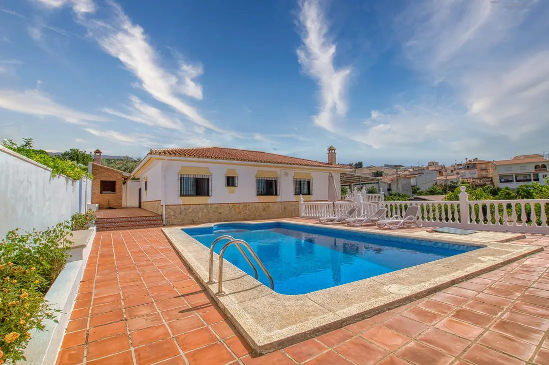 Country home — yet right in the village — with a pool and spectacular views of the mountains, the La Viñuela reservoir and the sea.